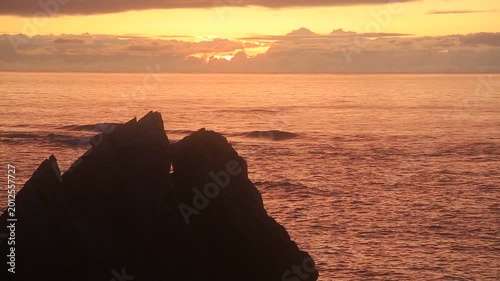Sunset over the East China Sea with rocky coast in Amami Oshima, Japan