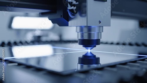 Automated CNC laser head cutting metal sheet in modern factory