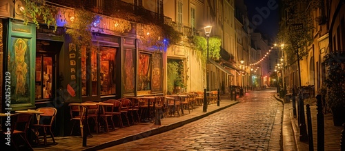 Experience the timeless charm of an enchanting European cobblestone street glowing under the warm amber light of a quiet city night.