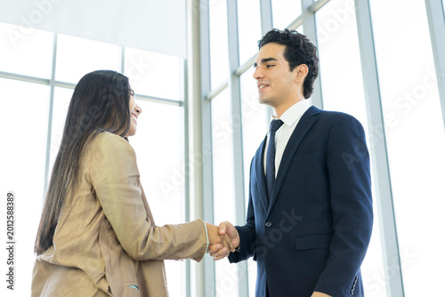 Young business people are shaking hands after a business deal. Successful negotiations or interview.