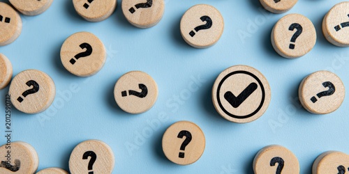 Wooden circles with question marks surround a single circle with a checkmark