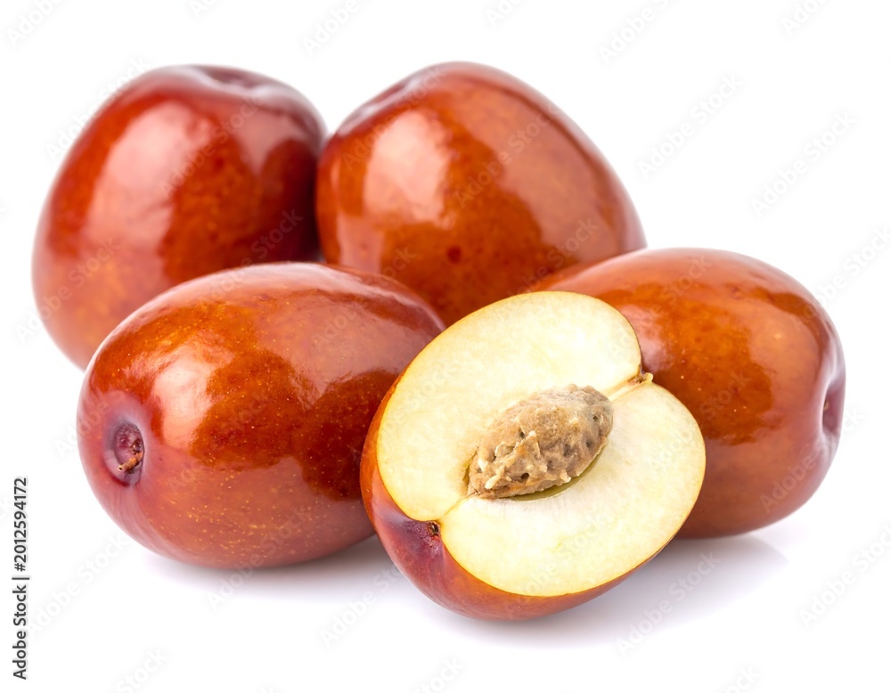 Fototapeta premium Whole and halved jujube fruits on white background
