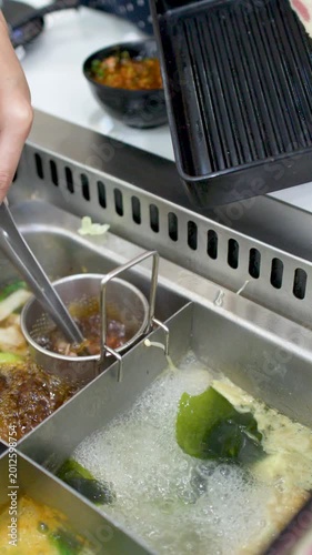 Raw Beef Slices Dipped into Boiling Shabu Shabu Hot Pot Soup