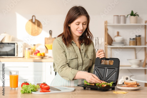 Young woman with ham using ...