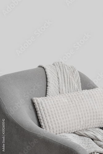 Grey armchair with pillow a...