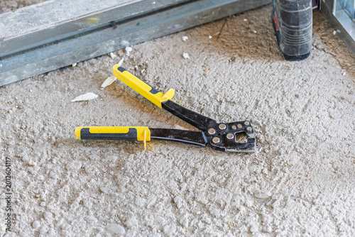 Canvas Print Drywall crimper tool on concrete floor construction site