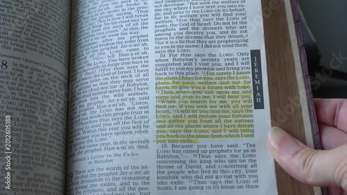 Holy Bible open up to the book of Jeremiah of the old testament, zooming into Chapter 29 verse 11 on The Lord plans to prosper and give hope. New Revised Stan