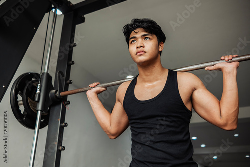 Принти на полотні Young athlete performs smith machine squats to strengthen legs, build lower body