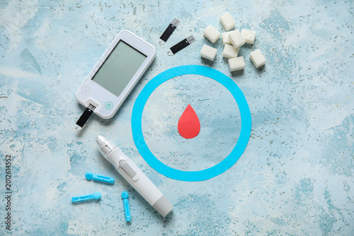 Tableau sur toile Glucometer with lancet pen, test strips, sugar cubes, ring and blood drop on blu