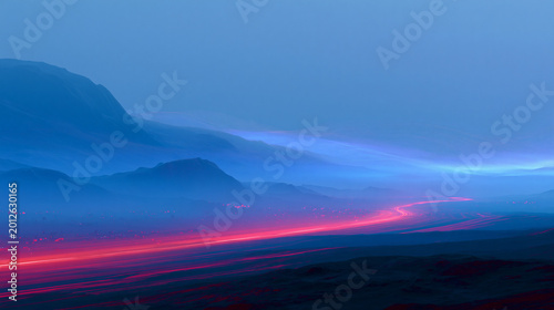 Neon Light Trails Across Misty Blue Mountain Valley