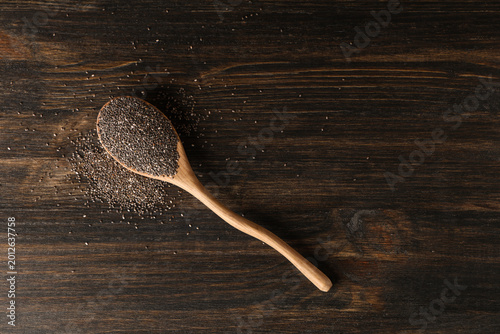 Spoon with chia seeds on wo...