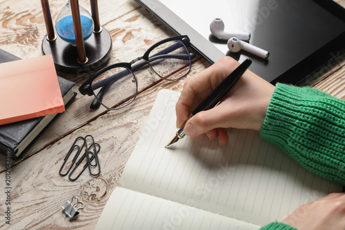 Female hands with notebook,...