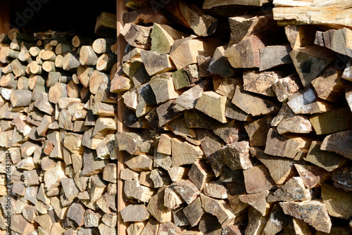 Stack of split firewood logs for winter heating, rustic wood pile