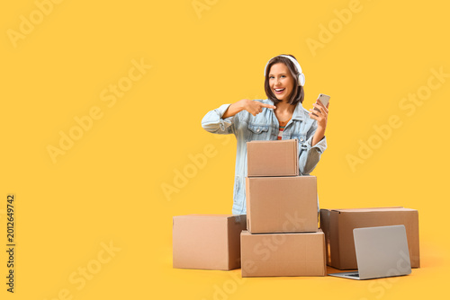 Young happy woman in headph...