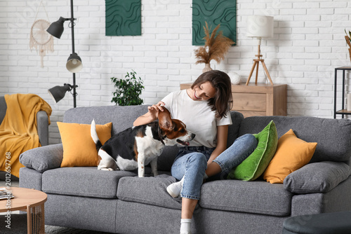 Young woman with cute Beagl...