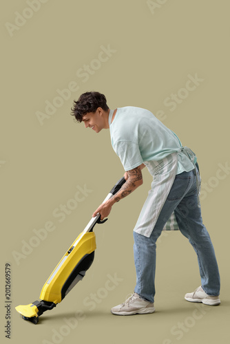 Young man with vacuum clean...