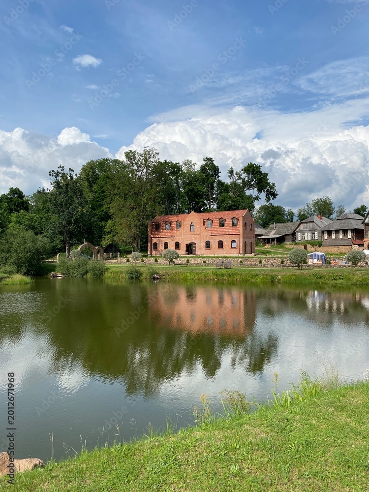 Fototapeta premium Landscape. Castle palace in lake water reflection. Castle reflection in lake water. Panorama.