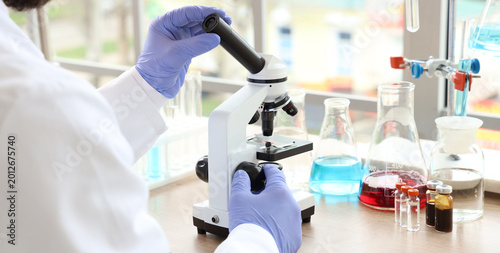 Male scientist with microsc...