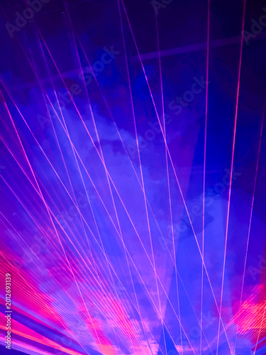neon laser beams and lights during live music concert on stage