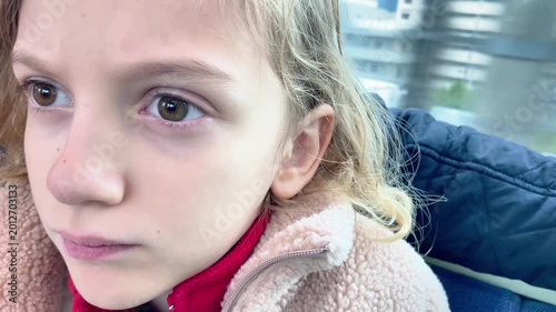  Tired young girl sitting in a subway car during a commute