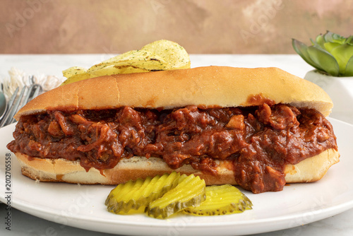 Photos barbecue  pulled pork sub  with potato chips and pickles