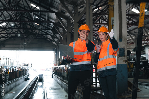 Engineers vehicles transportation logistic train worker teamwork inspection safety discussion planning supervision rail depot, engineers review vehicles movement and logistic operation