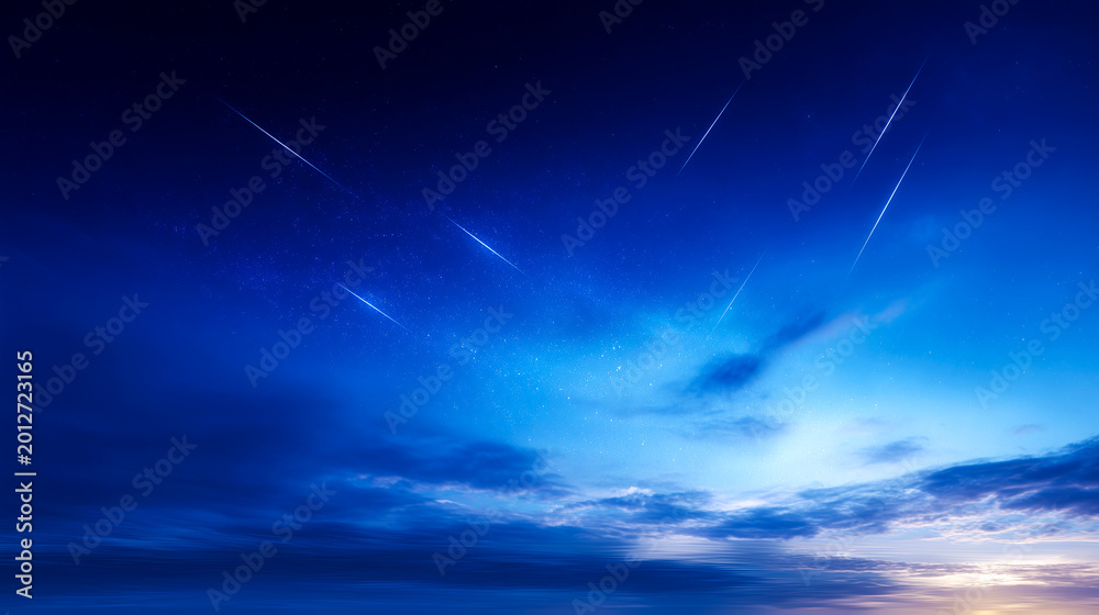 Fototapeta premium 深い青の夜空に降り注ぐ無数の流星群