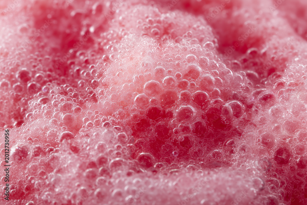 Fototapeta premium Macro of pink bubbly foam with glossy texture, fresh and vibrant style; abstract liquid concept for skincare, cleaning ads, beverages, backgrounds, and cosmetic branding