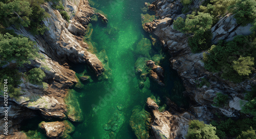 Aerial view of emerald river winding through rocky forest canyon; vivid natural style, symbolizing purity and wilderness, ideal for travel ads, eco branding, nature backgrounds and outdoor themes