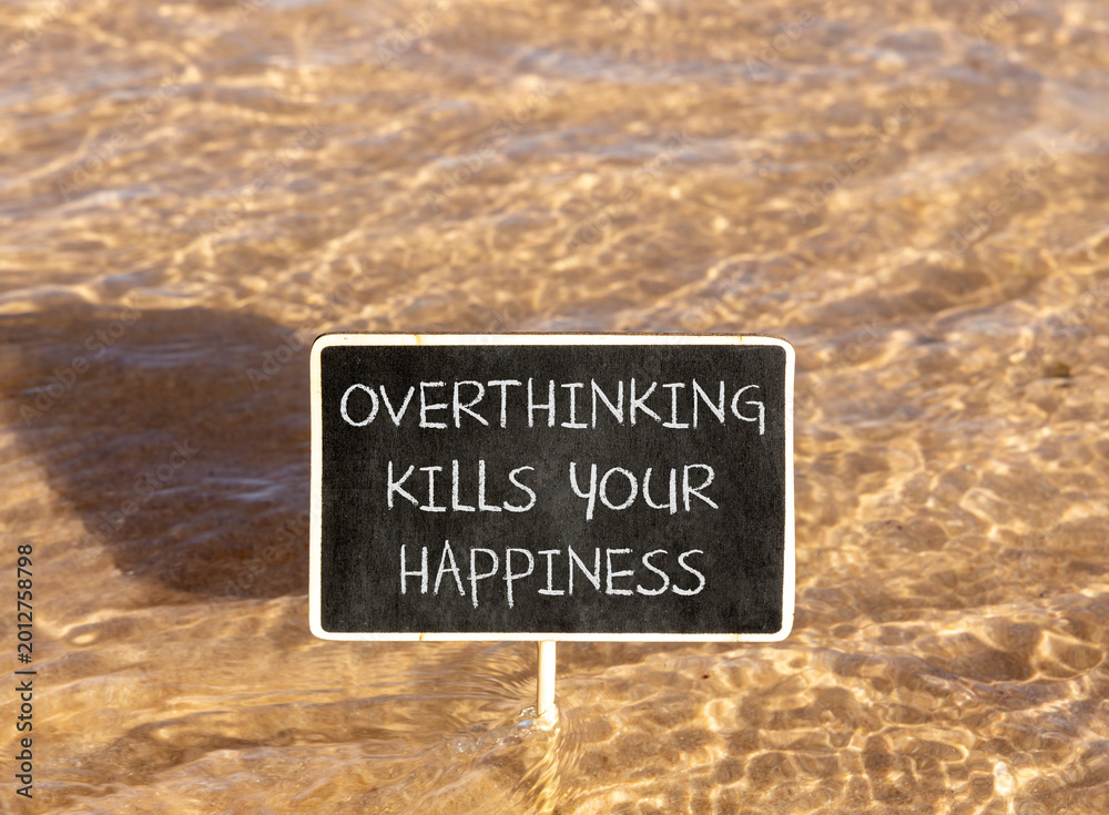 Naklejka premium Overthinking kills your happiness symbol. Concept words Overthinking kills your happiness on beautiful blackboard. Beautiful sea background. Business overthinking kills happiness concept. Copy space