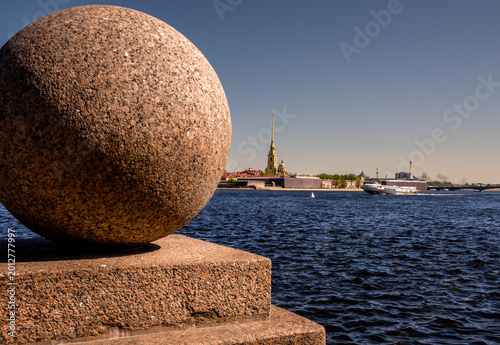 A large granite ball on a pedestal on the banks of the Neva River in St. Petersburg.