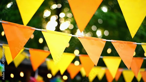 Colorful triangular flags strung together for a festive celebration outdoors.