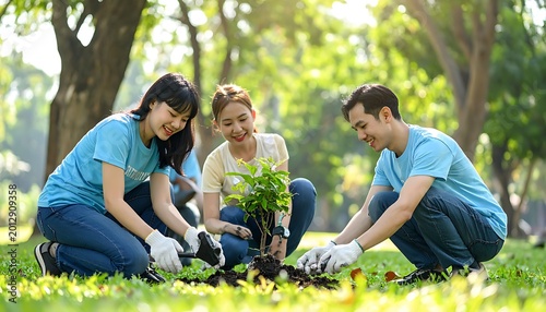 Volunteers planting tree in green park.