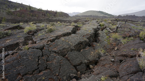 Rugged Black Volcanic Lava Field With Cracked Basalt Rocks In Craters Of The Moon Idaho USA