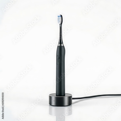 Black electric toothbrush on charging base
