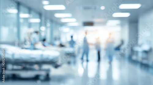 Naklejka Blurred view of a busy hospital ward with medical staff attending to patients in a healthcare setting.