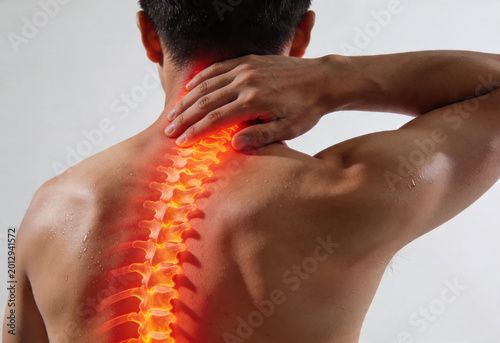Man holding neck experiencing pain inflammation ache nerve cervical spine person health medicine backview anatomy.