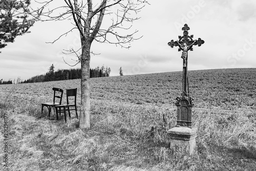 a chair, a tree, and a cross