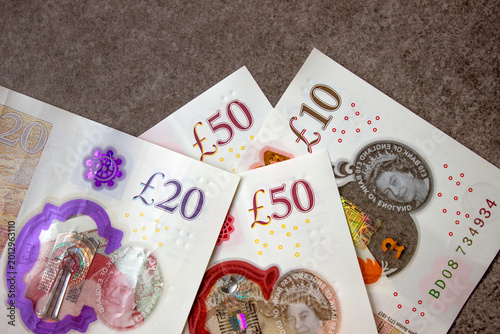 British pounds close-up on a chessboard background. National currency of Great Britain