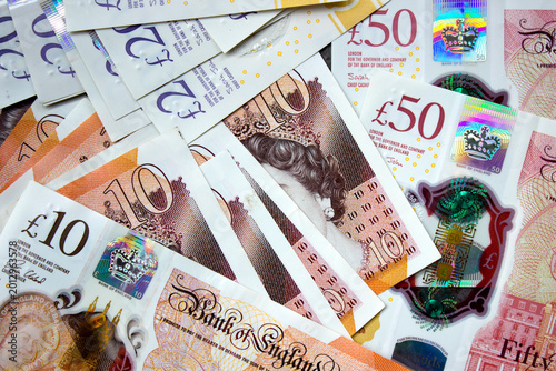 British pounds close-up on a chessboard background. National currency of Great Britain