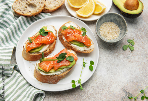 Bruschetta with salmon, avocado, and cream cheese