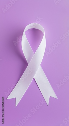 A white ribbon with the words stop violence on a purple background in a studio shot for awareness