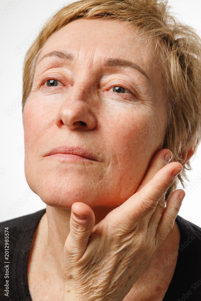 Fototapeta premium Closeup portrait of mature woman with eyes closed in beauty and self care concept.