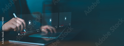 Cuadro en lienzo Businesswoman using tablet and laptop with digital video player interface for online streaming, media playback, video marketing, content creation and multimedia technology concept