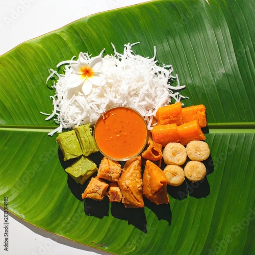 Assortment of sweet treats, arranged artfully on a large, vibrant green banana leaf