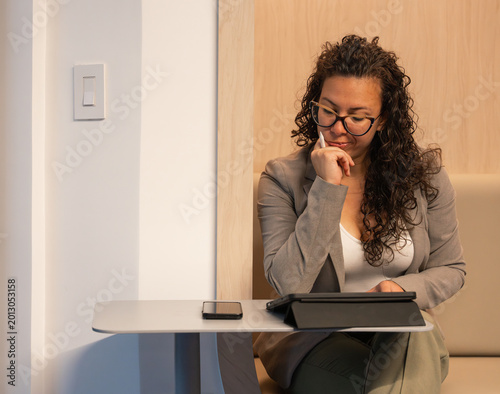 Принти на полотні Professional woman thinking, concentrating on working with tablet