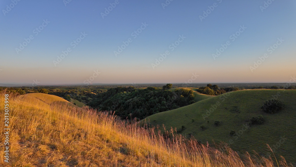 Obraz premium Tranquil sunny summer landscape with green fields and hills in south-eastern Europe, Serbia.