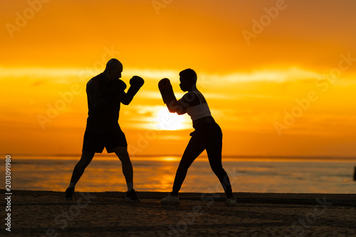 Fotografie People training boxing at sunset inspiring fitness and willpower