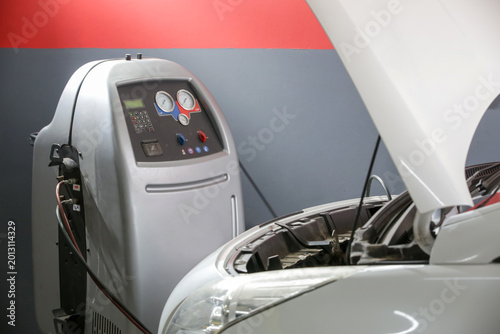 Car Air Conditioning Recharge Service with Freon Machine in Auto Repair Shop - Car AC Maintenance and Refrigerant Recharge Equipment in Garage
