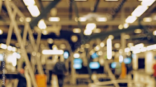 Blurred modern factory interior with workers